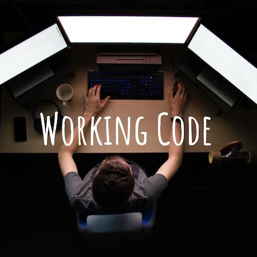 Working Code Podcast: A person sits at a desk with 3 brightly lit monitors in a dark room