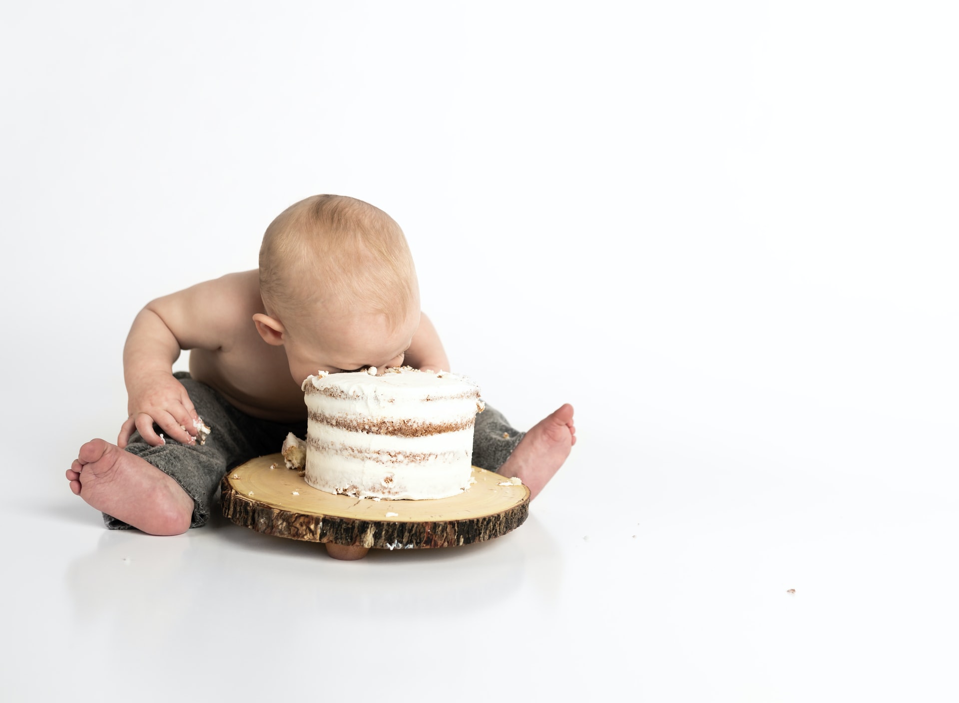 Baby chowing down on birthday cake