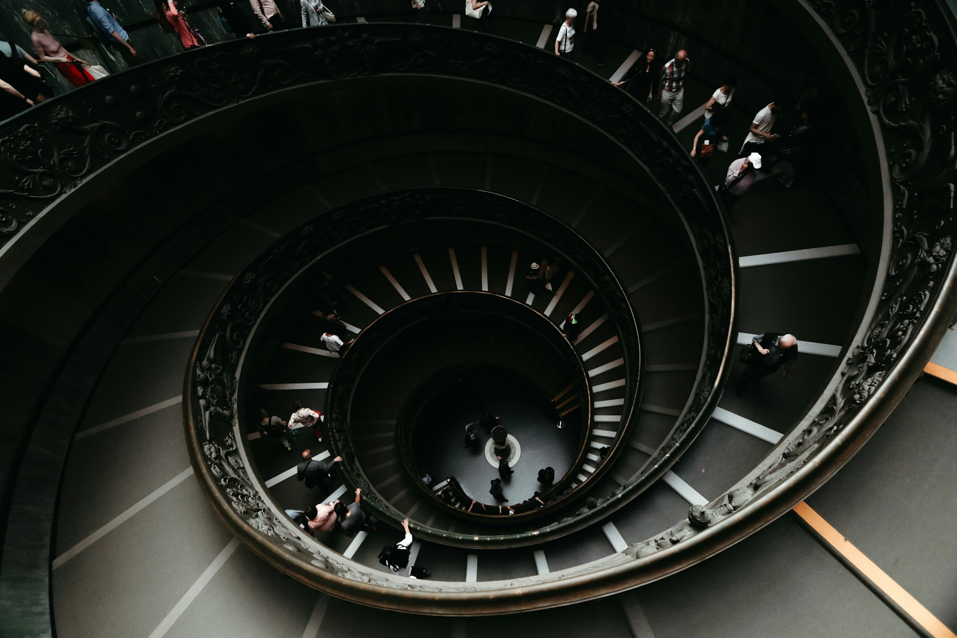 A dark and moody view down a spiraling staircase